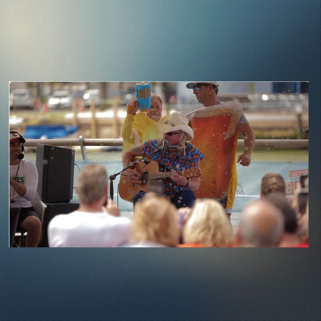 A man and woman perform at an outdoor event in front of an audience.
